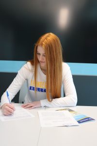 Tori Dauvin signs her Thunderwolves women's volleyball commitment papers