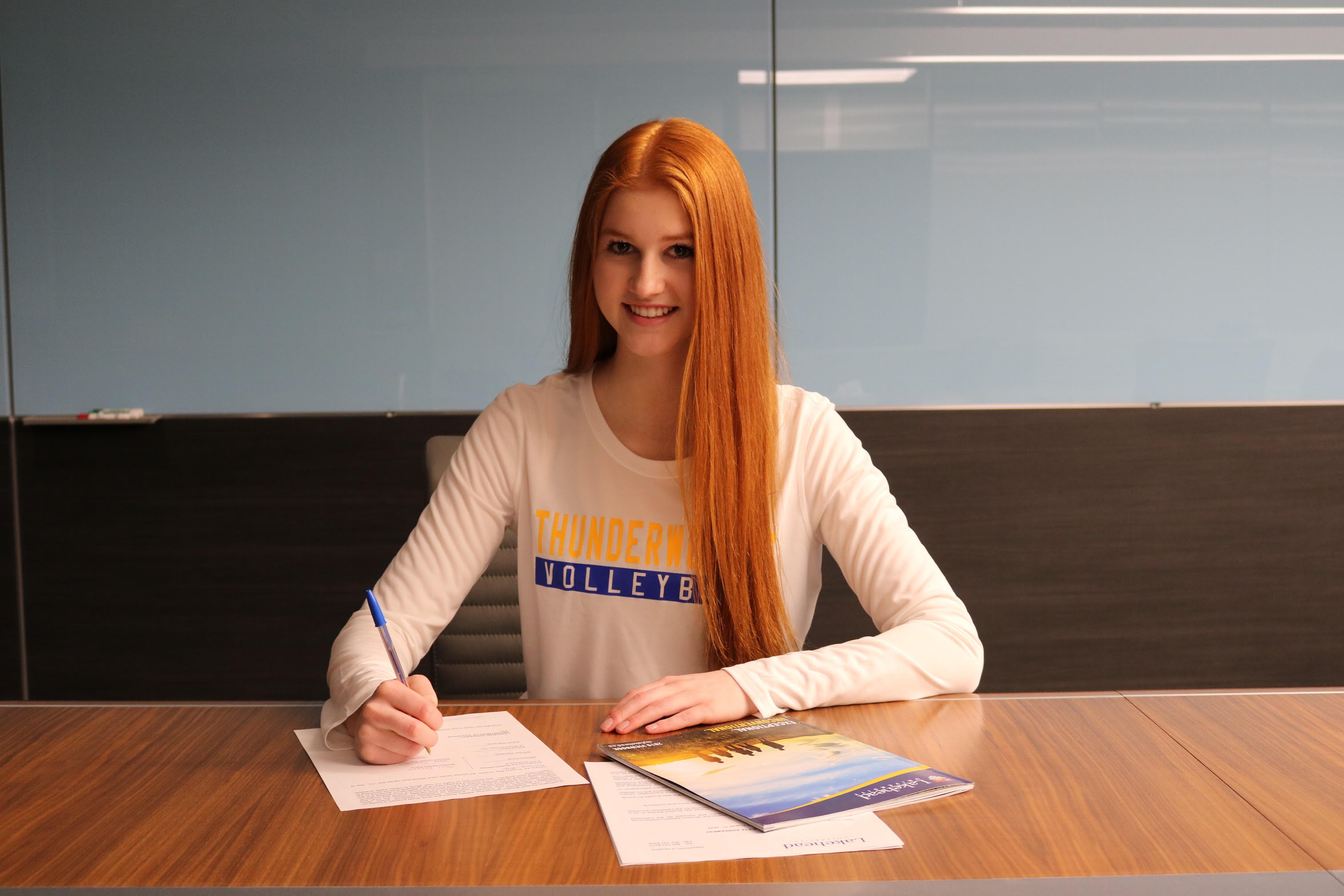 Tori Dauvin signs her Thunderwolves women's volleyball commitment papers,